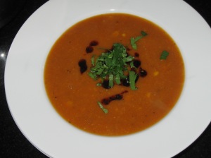 sweet potato and corn soup garnished with chorizo oil and coriander